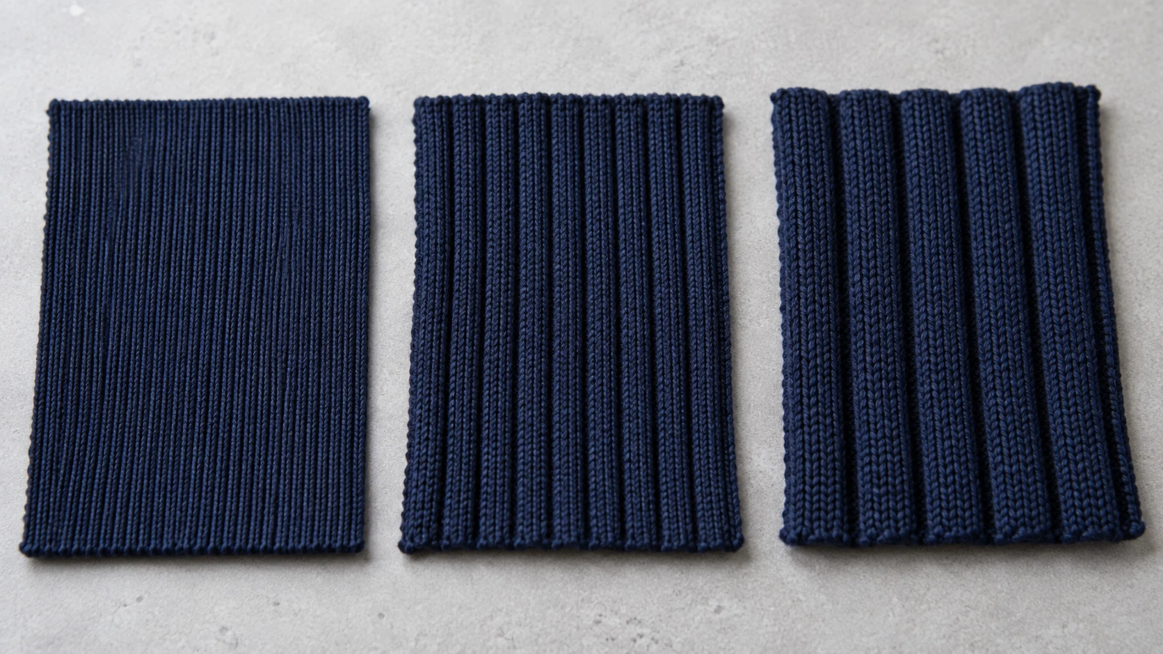 Three navy rib-knit fabric swatches with visibly different rib structures