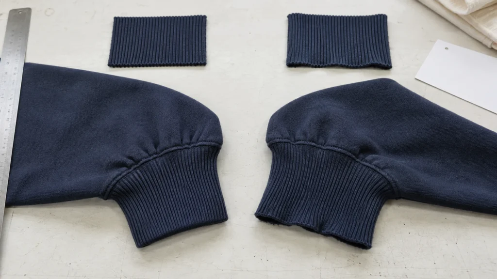 Navy sweatshirt cuffs comparing good rib recovery with a wider flared cuff